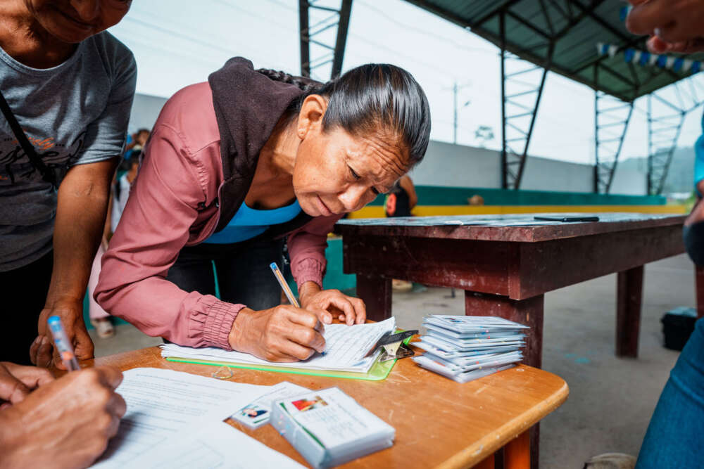 A cocoa farmer fills in a form