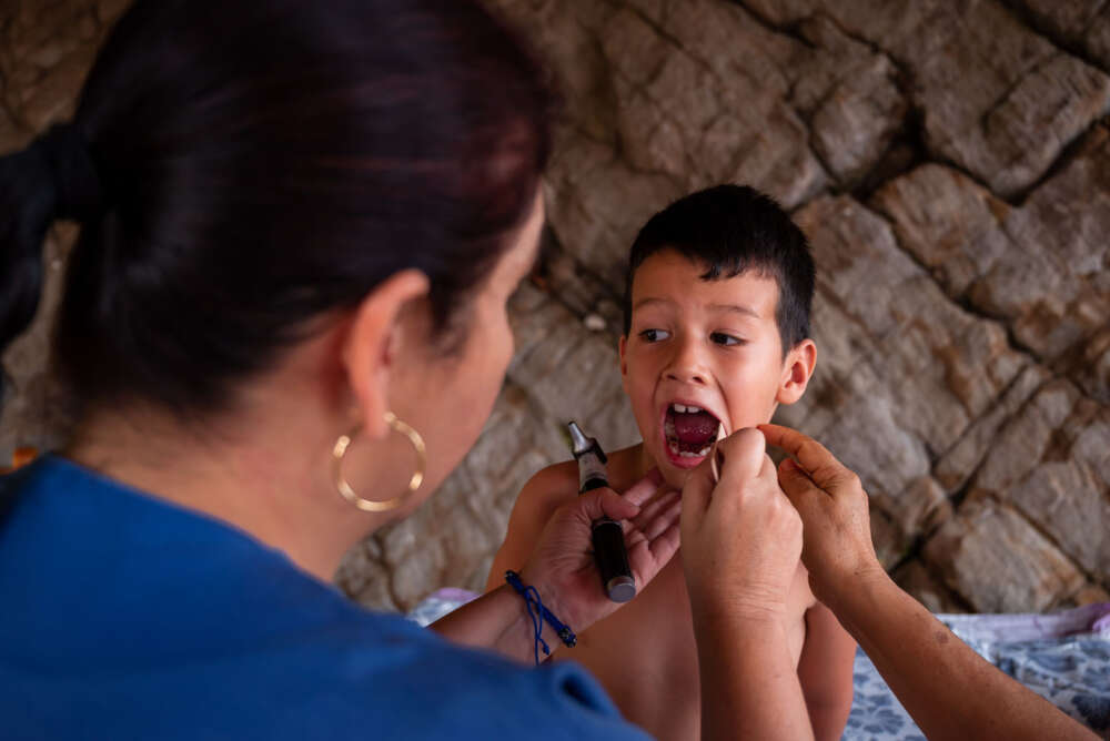 Doctor examines a boy in Venezuela