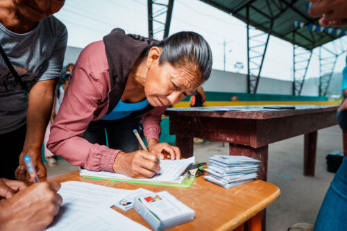 A cocoa farmer fills in a form