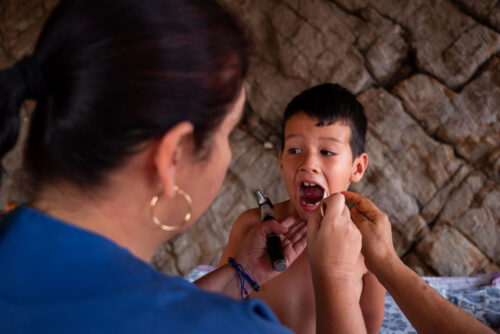 Doctor examines a boy in Venezuela